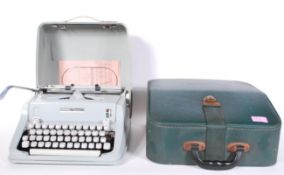 A vintage Hermes Media 3 Swiss made 20th Century portable typewriter in case, together with a faux