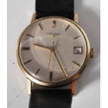 A vintage gentleman's 9ct gold Longines wrist watch having a round face with a silvered dial with