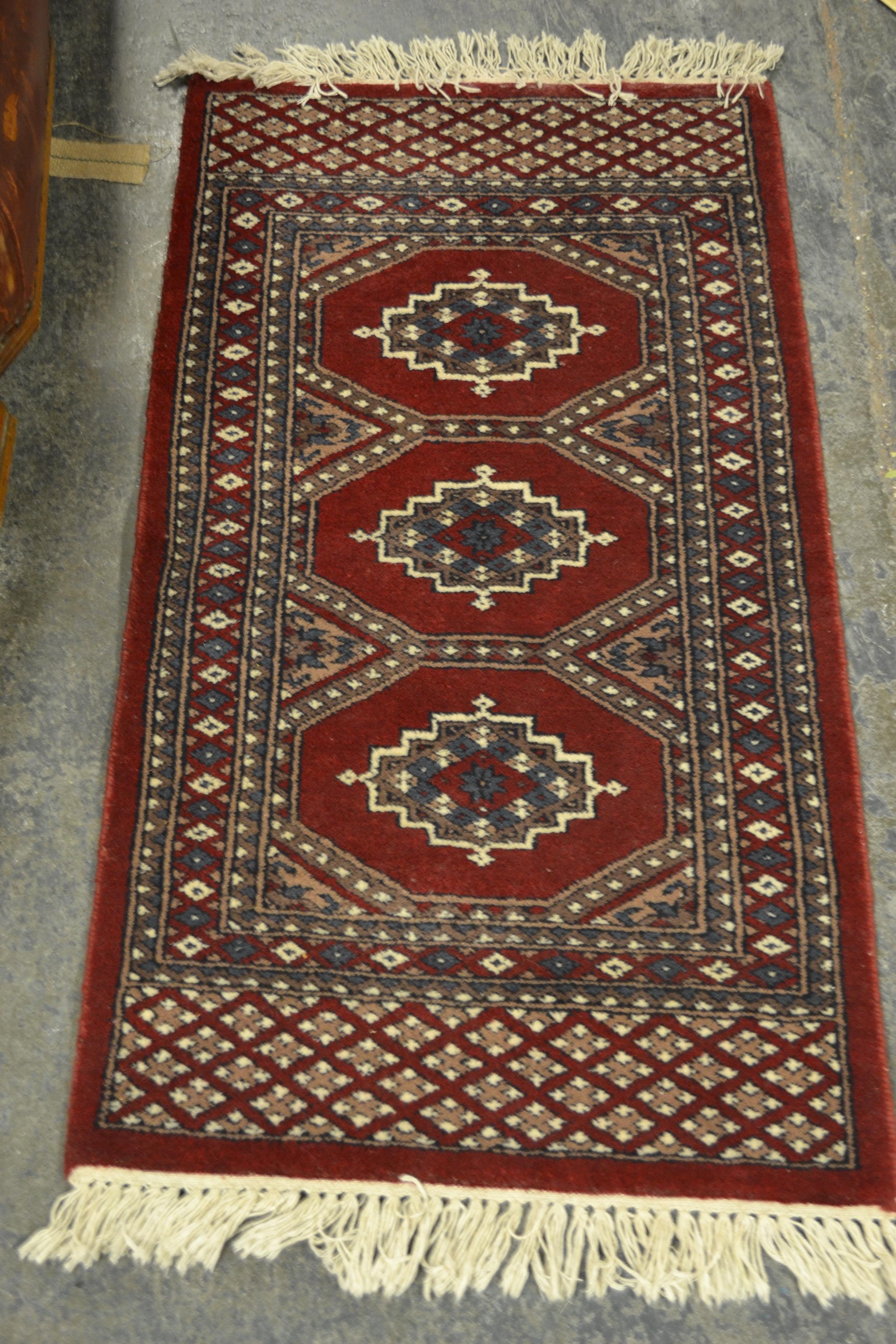 A 20th Century hand knotted floor rug carpet of large proportions in a Bukhara design having a red - Image 4 of 6
