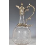 A 20th Century claret jug of bulbous tapering form having a faceted neck with etched foliate