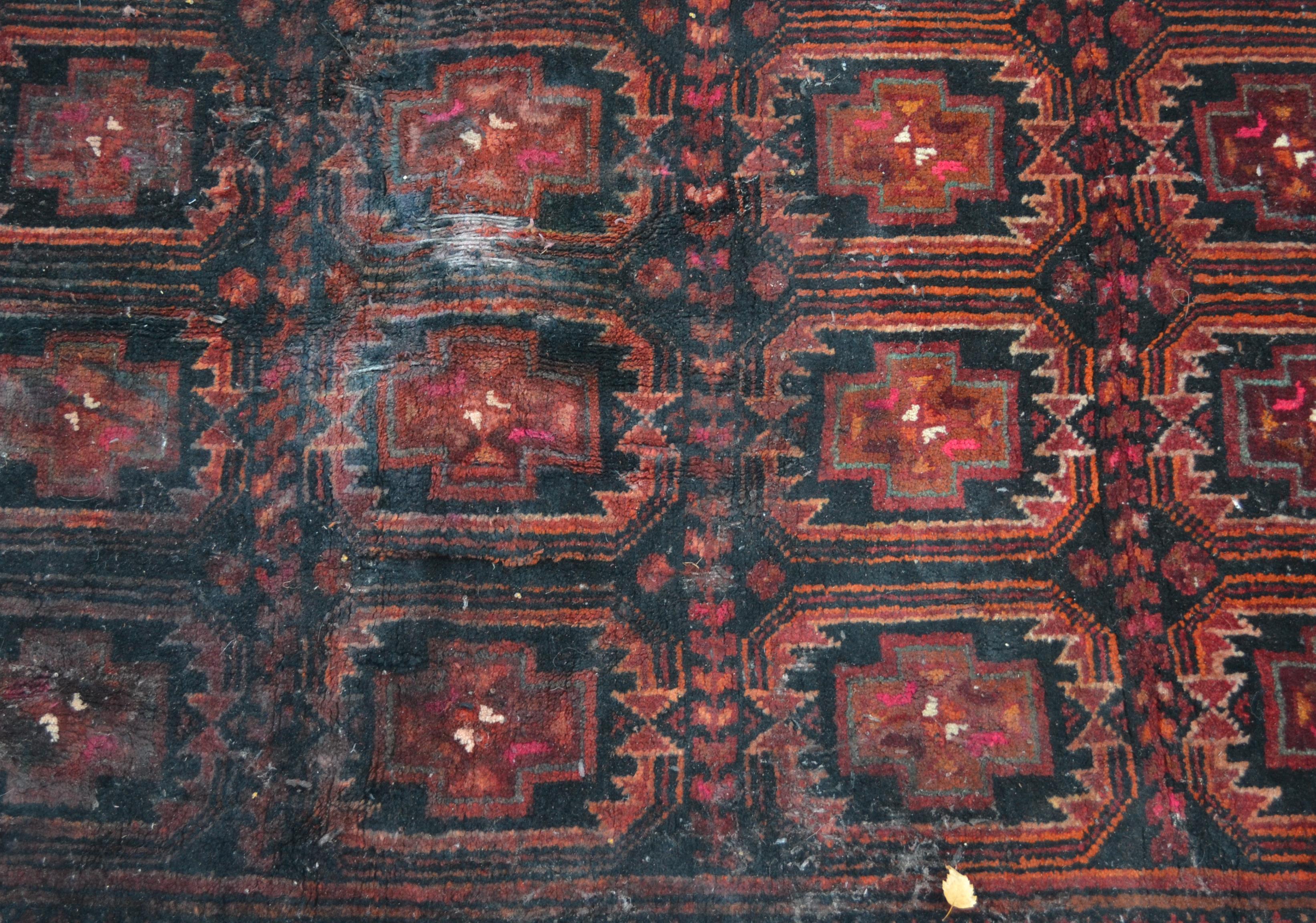 A 20th century dark red and blue ground Persian / Islamic Bokhara rug having a central panel of - Image 2 of 4