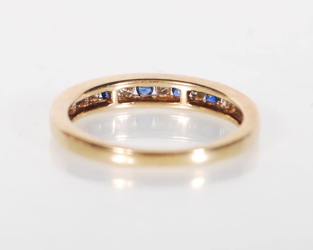 A stamped 9ct gold ring being channel set with alternate blue and white stones. Weight 2.3g. Size - Image 3 of 6