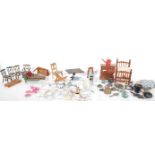 A collection of doll's house furniture and ornaments dating from the 19th Century onwards to include