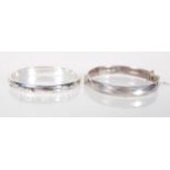 Two 20th Century silver bangle bracelets having hinged openings to include an English hallmarked