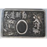 A 20th Century Chinese cast metal desk top inkwell having embossed decoration with a female
