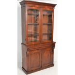 A Victorian 19th century mahogany library bookcase cabinet. Raised on a plinth base with cupboards