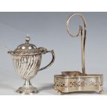 A silver hallmarked cruet condiment holder of trefoil form having pierced decoration with a loop