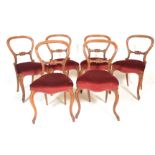 A set of six 19th Century Victorian mahogany balloon back dining chairs raised on carved cabriole