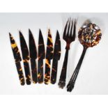 A selection of early 20th Century carved tortoise shell salad servers, the spoon having pierced