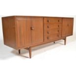 A mid century teak wood Danish inspired sideboard credenza by Ensign. Raised on shaped legs having a