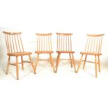 In the manor of Ercol - A set of four 20th Century vintage beech and pine stick back dining chairs