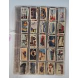 A collection of vintage 20th Century cigarette trade cards to include three full sets; Godfrey