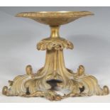 A 20th Century cast brass tazza stand raised on a scrolled acanthus leaf base with round plate to