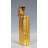 A vintage 20th Century Dunhill rollergas cigarette lighter of rectangular form having a gilt