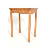 An early 20th Century walnut card table of small proportions fold over top lined with green baize,