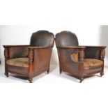 A pair of 1930's vintage faux brown leather arm chairs having oak shaped arm rests with patterned