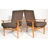 A pair of retro 20th century armchairs. Raised on shaped -a-frame legs with arched stretcher under