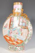 A 19th Century Chinese Canton famille rose moon flask decorated with interior narrative scenes to