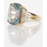 A 9ct gold hallmarked dress ring having an oversized cut blue iridescent stone  mounted in a prong