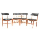 A set of four teak G-plan dining chairs designed by Kofod Larsen. Raised on tapered turned legs with