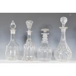 A collection of four cut glass decanters dating from the 19th Century. Each of different designs