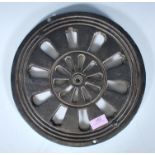 A 19th Century Victorian cast iron wall mounted air vent of round form with the smaller backplate