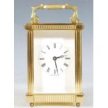 A vintage brass Carriage Clock of five-glass form, English made, white enamel face having a Roman
