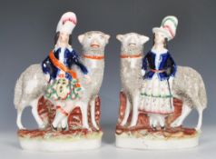 A pair of 19th Century Staffordshire polychrome flatback figurines depicting tall wooly sheep with