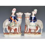 A pair of 19th Century Staffordshire polychrome flatback figurines depicting tall wooly sheep with