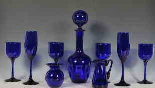 A group of Bristol Blue glass to include a decanter having a large round stopper, wine glasses and