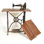 A late 19th Century treadle sewing machine table of mahogany and cast iron construction with pierced