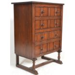 A 1920's stained pine chest of drawers on stand. Raised on turned leg fixed stand united by