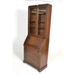 An early 20th Century oak bureau bookcase, glazed panel doors with adjustable shelves over fall