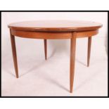 A retro mid Century 1960's teak wood G-Plan extending dining table of round form raised on