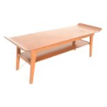 A retro 20th Century teak wood surfboard style coffee table raised on shaped supports with a solid
