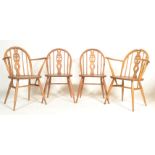 A set of 4 20th century Ercol beech and elm wood ' Fleur de Lys ' pattern dining chairs. Each raised