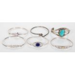 A selection of 20th Century silver bangle bracelets to include four having hook and eye clasp