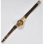 A vintage ladies 9ct gold Bulova Quartz cocktail watch having a round face with gilt dial with baton