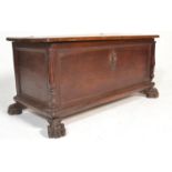 A 17th Century Italian walnut cassone marriage chest / coffer being raised on ball and claw feet