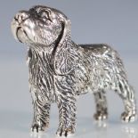 A small silver figurine in the form of a dog. Stamped sterling to base. Weighs 20.3g. Measures 3cm