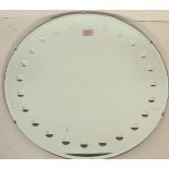 A mid 20th century vintage retro frameless mirror of round form having repeating circular design