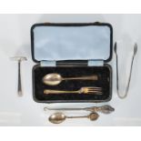 A collection of silver hallmarked items to include a cased silver fork and spoon, sugar tongs,