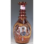 A vintage 20th Century Cranberry glass Bohemian style decanter decorated with three panels of a
