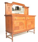 An early 20th Century 1920's light oak sideboard having a raised arched back with central mirror