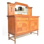 An early 20th Century 1920's light oak sideboard having a raised arched back with central mirror