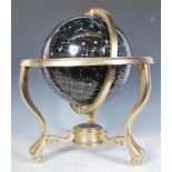 A 20th Century desktop stargazing constellation globe within a brass gimbal stand raised on three