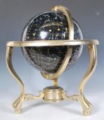 A 20th Century desktop stargazing constellation globe within a brass gimbal stand raised on three