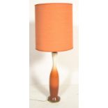 A vintage retro mid 20th Century desk / table top lamp having a flow orange ceramic base with an