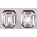 A pair of silver stud earrings set with emerald cut CZ's. Stamped 925. Gross weight 2.9g. Measures