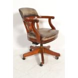 A 20th century mahogany and leather captains office swivel desk chair. The mahogany base with reeded